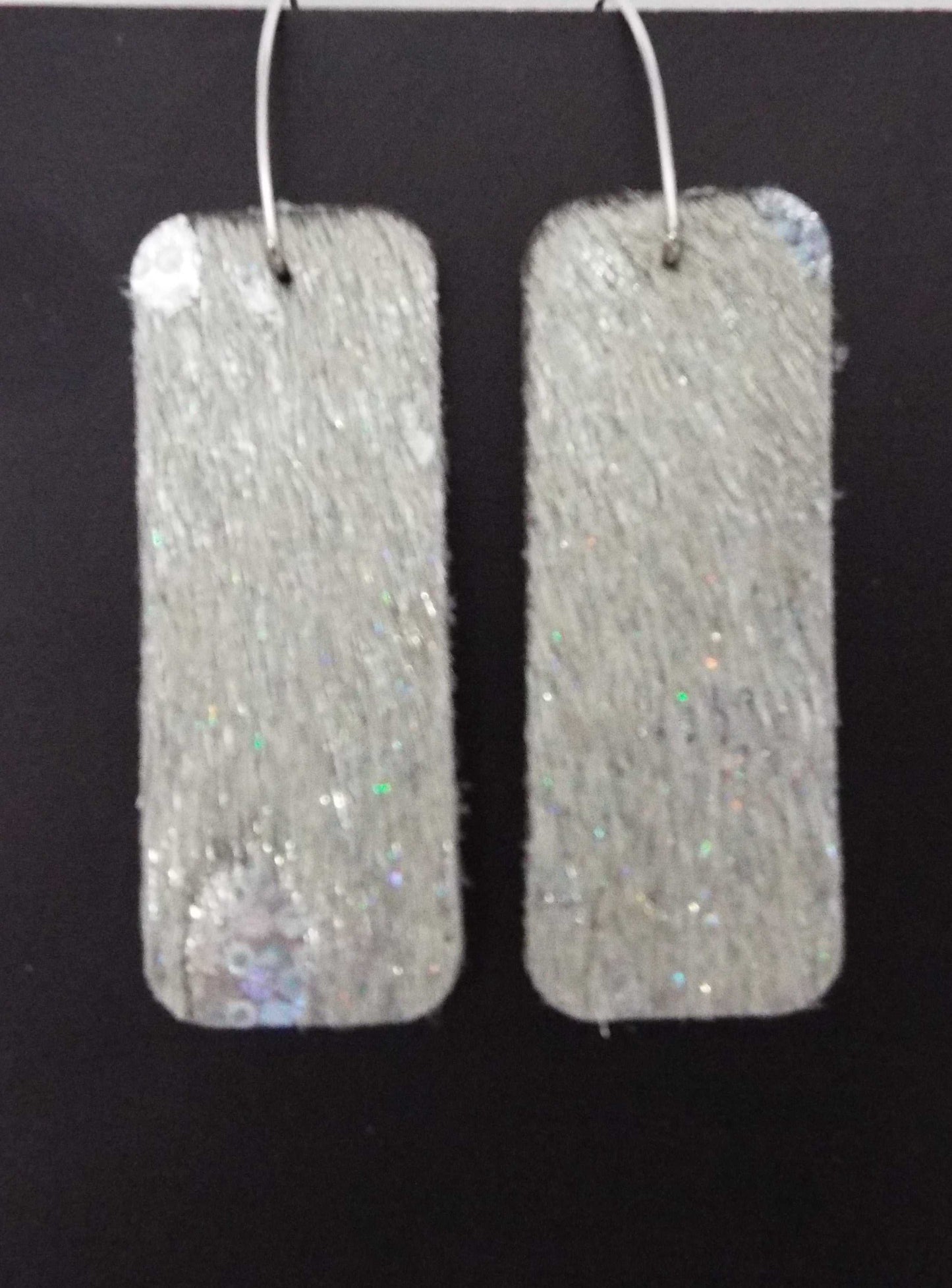 Silver glittery leather earrings made in USA for bold style