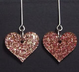 Pink heart dangle earrings with chunky glitter and heart cutouts, perfect for Valentine's Day.