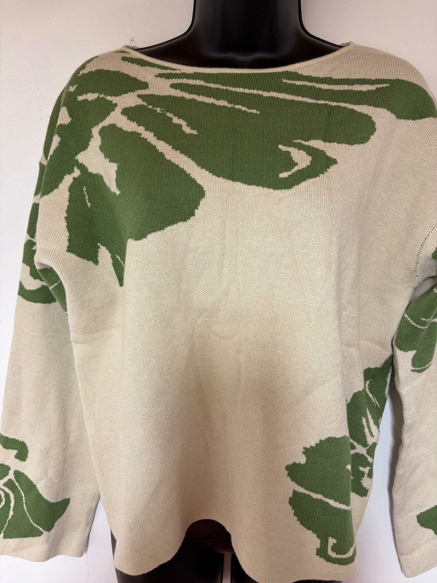 Green floral sweater with vivid botanical prints on rich verdant knit fabric